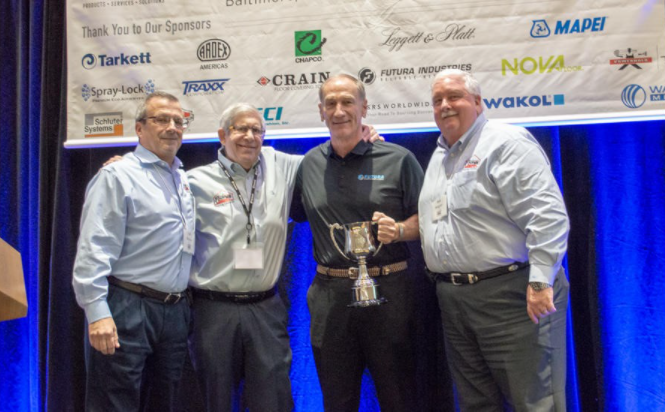 Doug Mayeux of Futura Industries received the Spirit of Excellence Vendor Representative Award from Fishman Flooring Solutions at the firm's recent sales meeting. He is flanked by (from left) Bill Mabeus, Len Goldheim and Bob Wagner.
